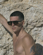 Le Specs Subzero Black Wide Fit Sunglasses lifestyle beach image